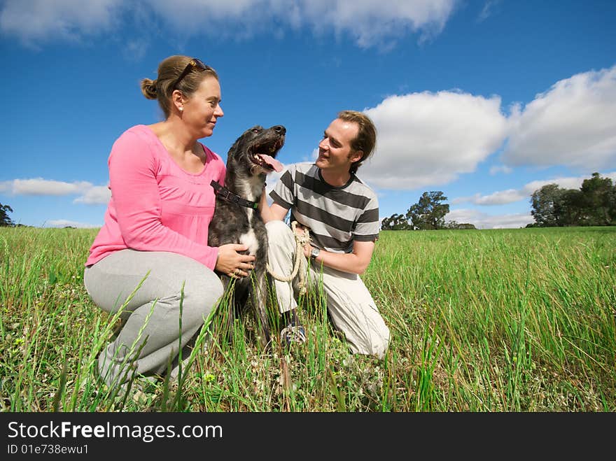 Couple With Dog In Field