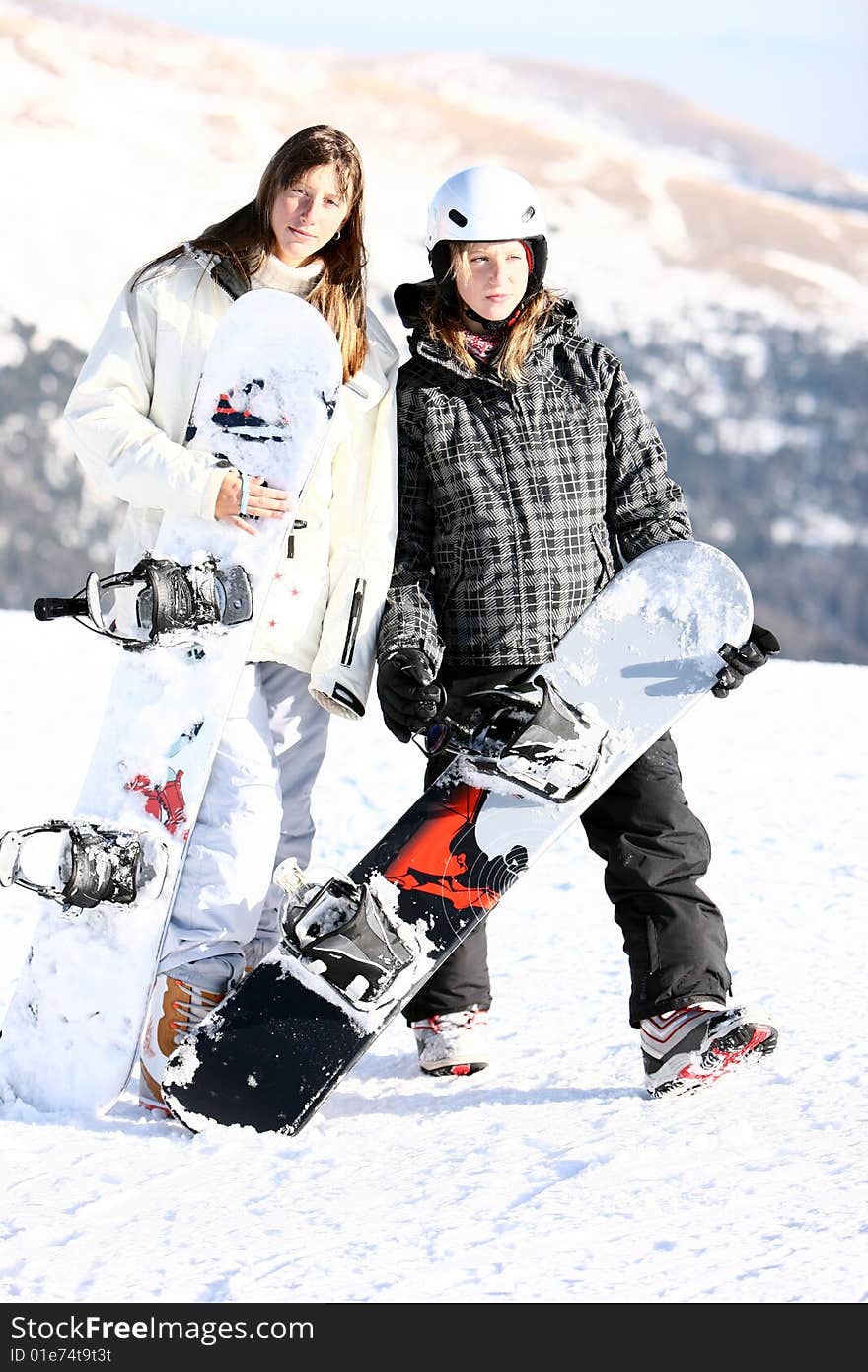 Two girls with snowboards