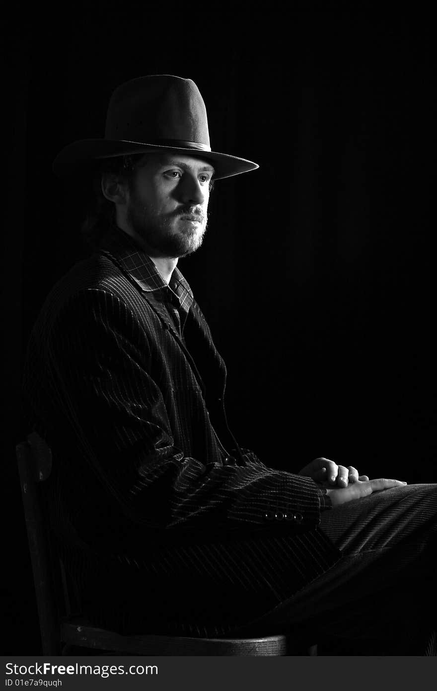 Stock photo: an image of a man in a grey hat on black background. Stock photo: an image of a man in a grey hat on black background