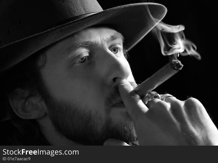 Stock photo: an image of a man in a hat with a cigar. Stock photo: an image of a man in a hat with a cigar