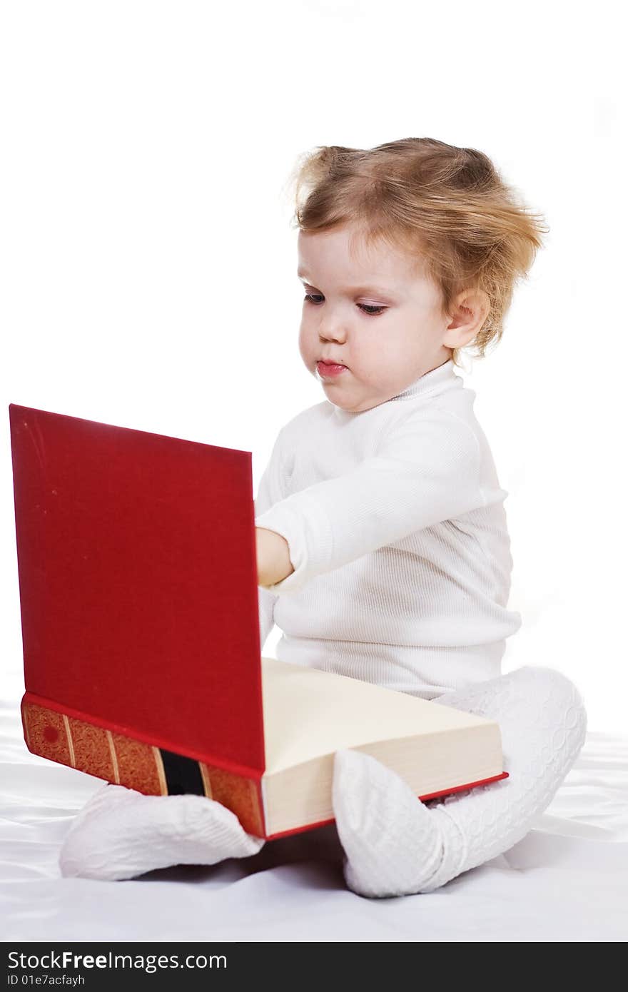 Stock photo: an image of a little girl with a big book. Stock photo: an image of a little girl with a big book