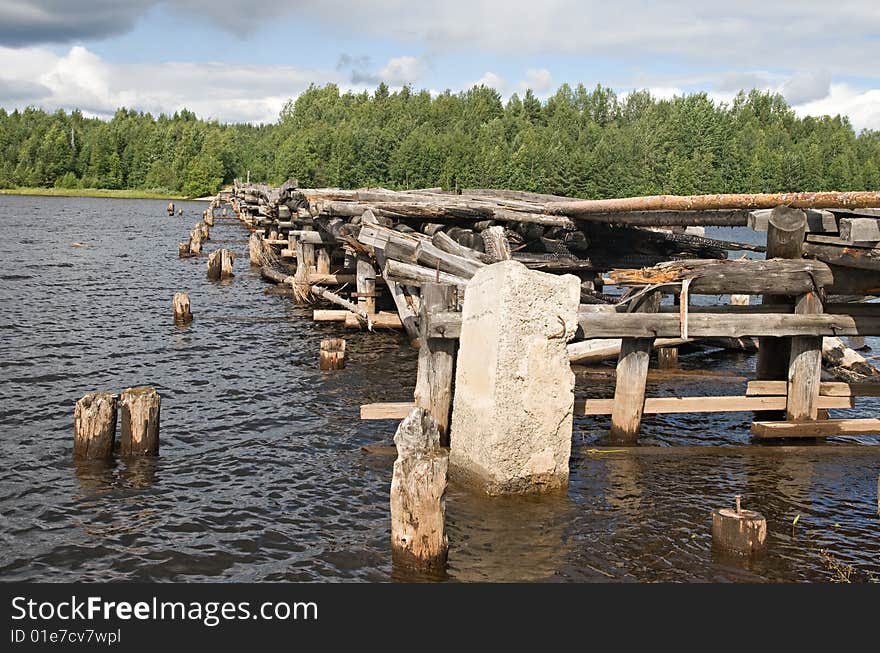 An old broken bridge on a river in Karelia, Russia