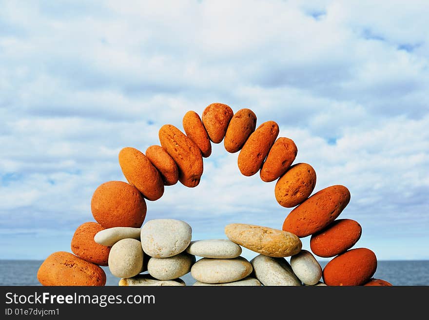 Red brick arch on seacoast with the cloudy sky. Red brick arch on seacoast with the cloudy sky