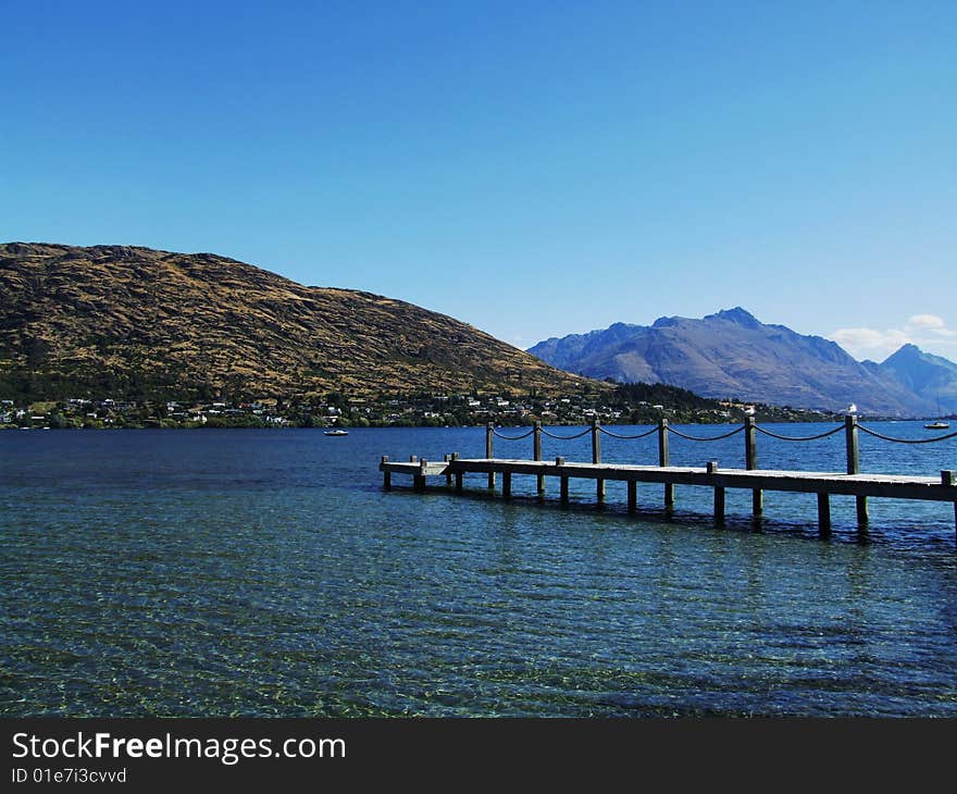 Lake with pier and mountains