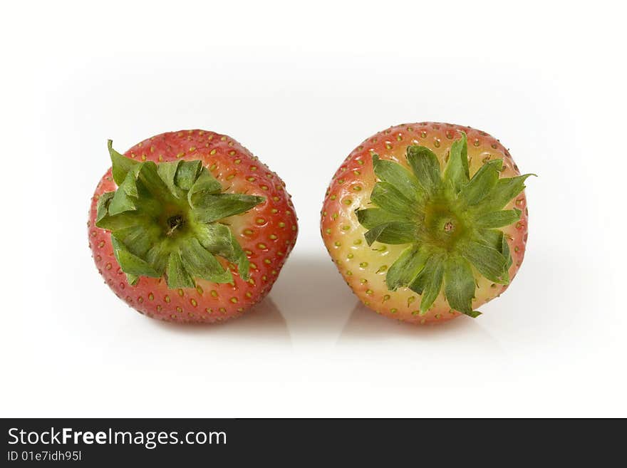 Two red strawberries on white background