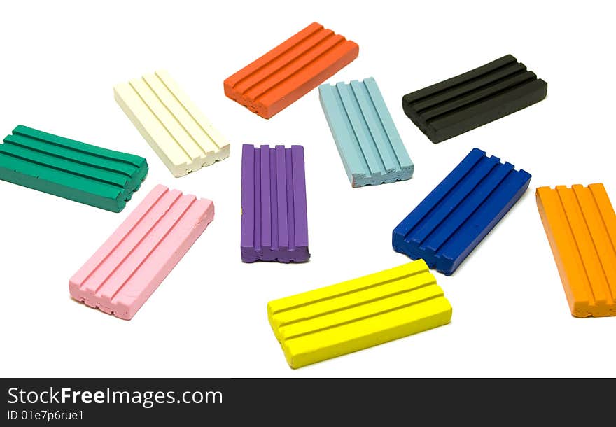 Colorful plasticine bricks on white