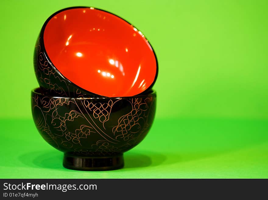 Black and Red Rice Bowls on a Green Background.