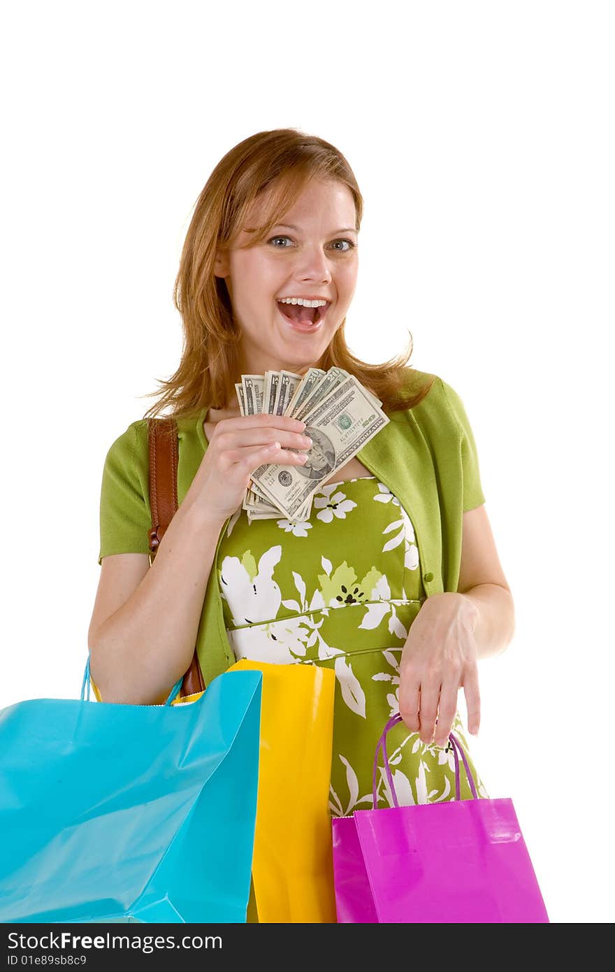 Attractive woman carrying a purse, shopping bags, and a handful of money. Attractive woman carrying a purse, shopping bags, and a handful of money