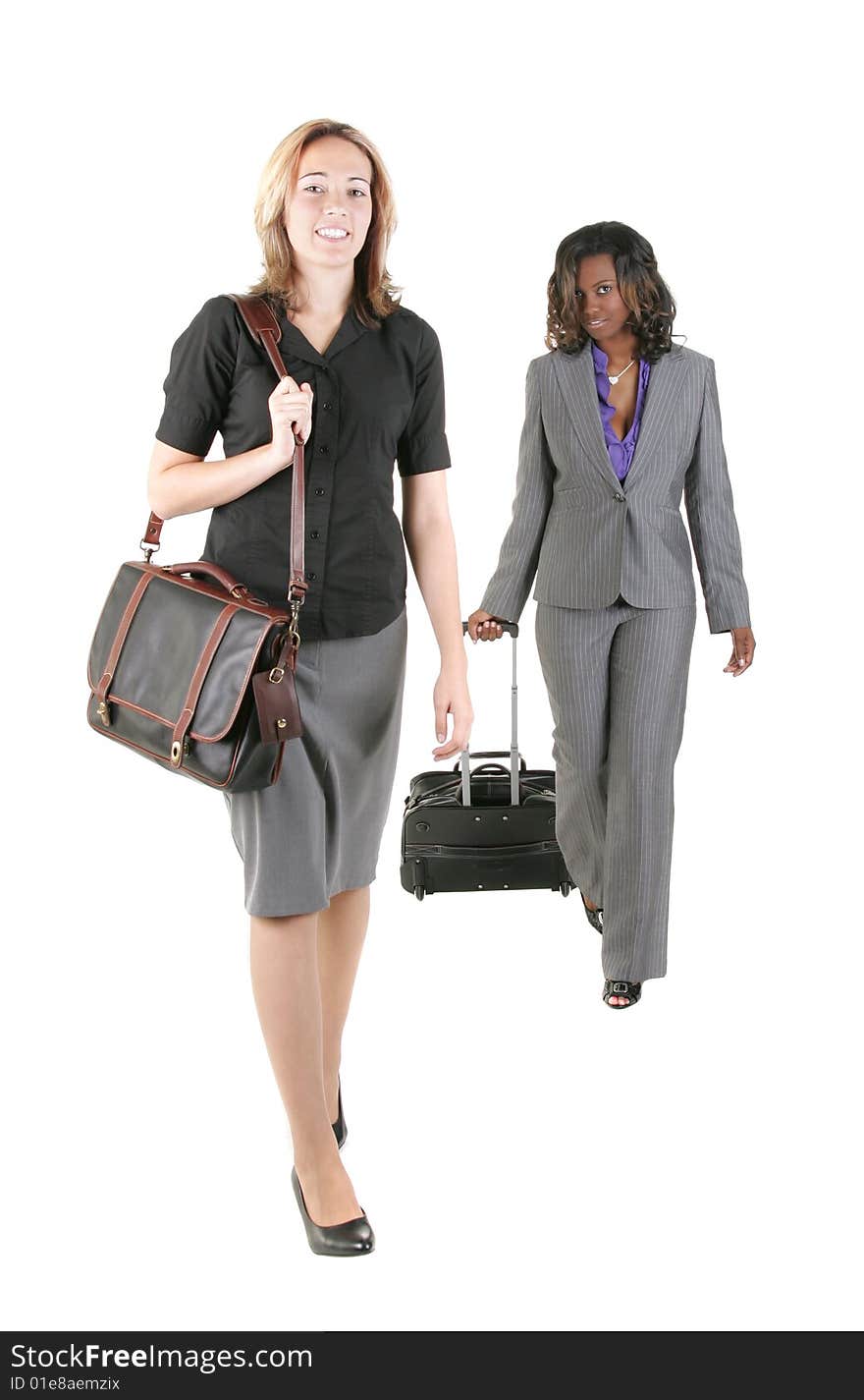 Two young business people walking towards the camera