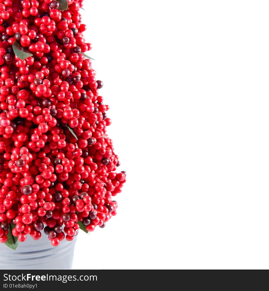 Red berry tree in a small metal pot.