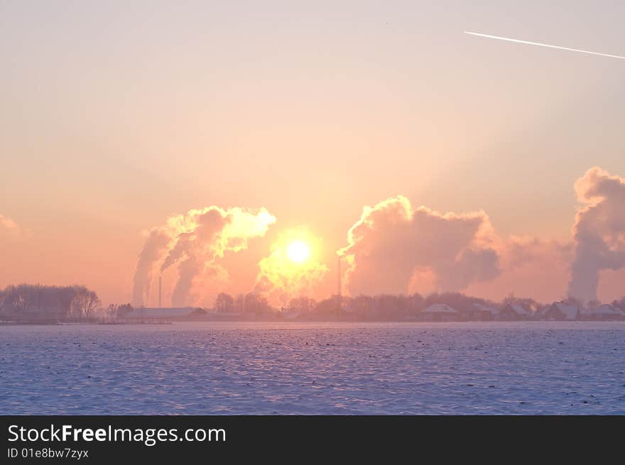 Nice winter landscape with industrial smokers with pale sunset. Nice winter landscape with industrial smokers with pale sunset