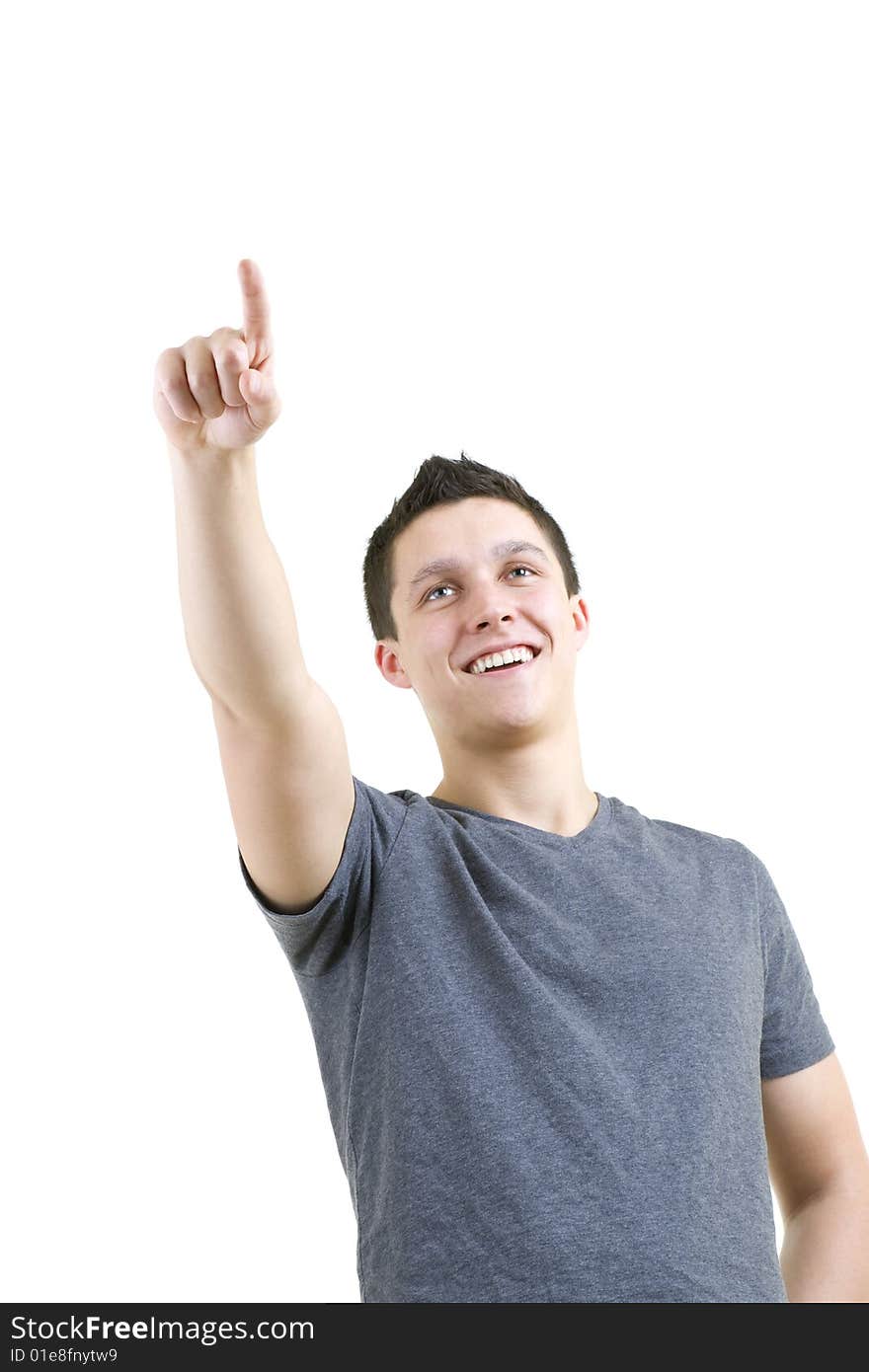 Handsome young man isolated on a white background and pointing to copy space