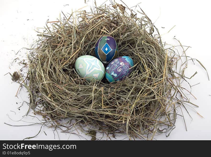 Handmade colored Easter eggs in the nest