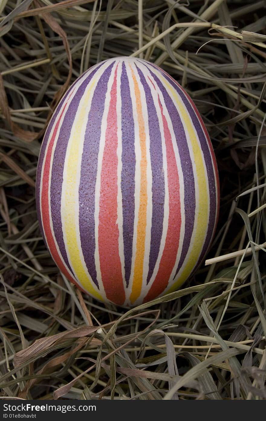 Handmade colored Easter egg in the nest