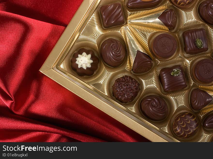 Chocolates box on red satin