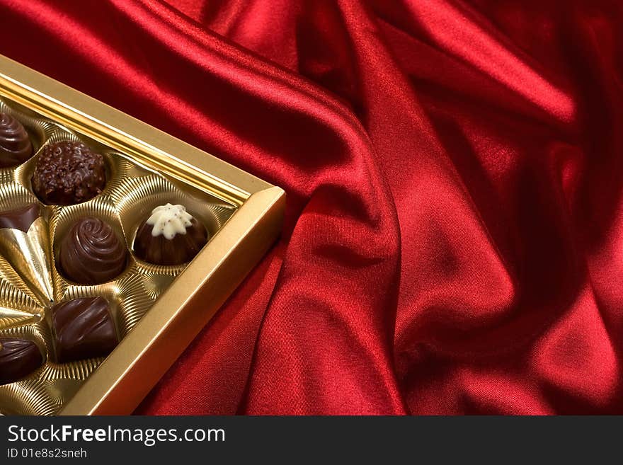 Chocolates box on red satin