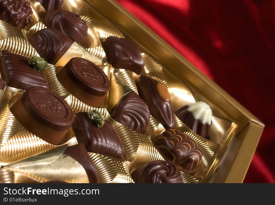 Chocolates box on red satin