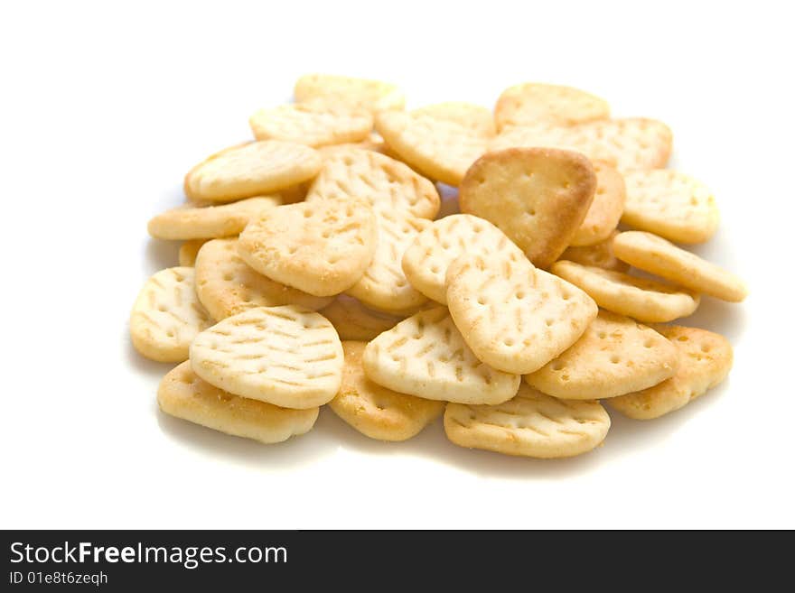 Yellow salty crackers on white ground