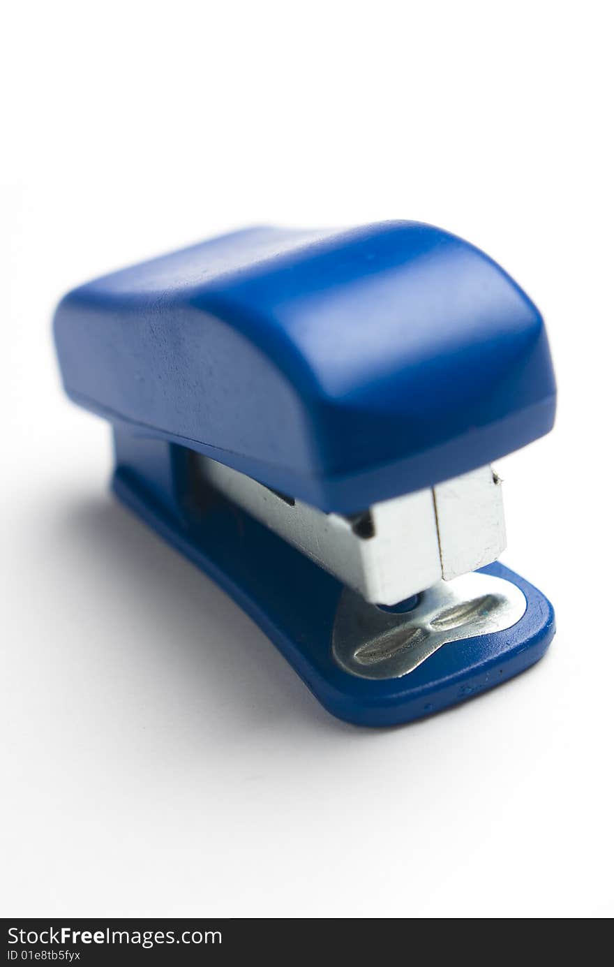 Blue stapler on white background.