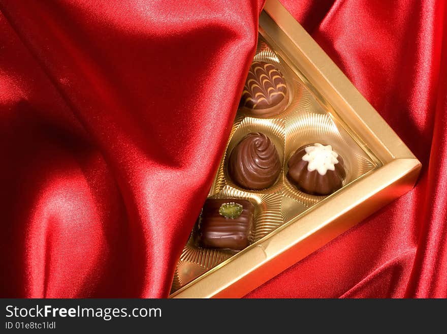 Chocolates Box On Red Satin