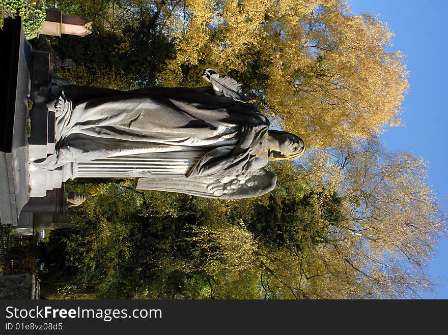 Stone angel at the cemetery, Autumn scene