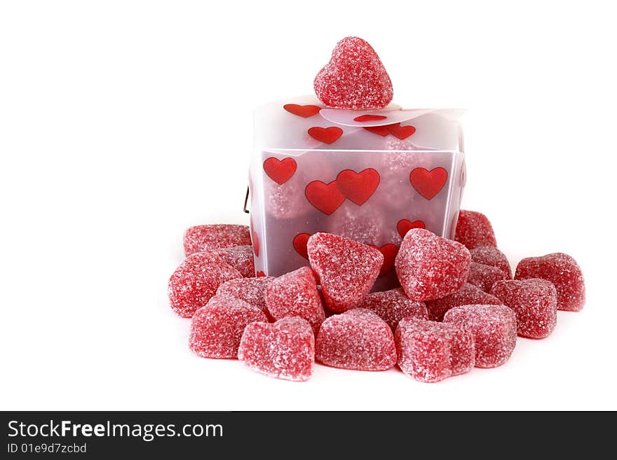 Gummy cinnamon heart surrounding a heart covered Chinese take out style box on an isolated background. Gummy cinnamon heart surrounding a heart covered Chinese take out style box on an isolated background