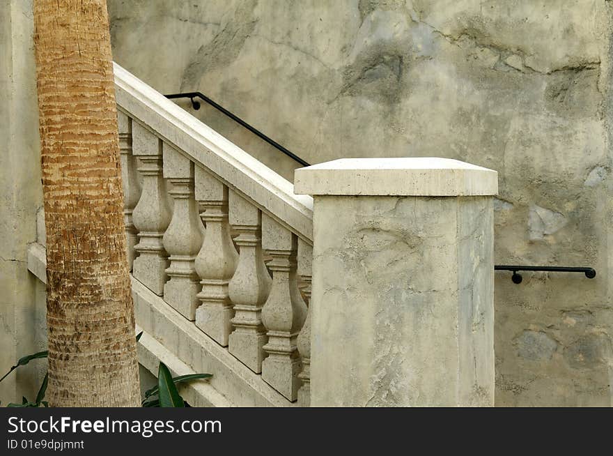 An image of marbled stone railings leading to a terrace