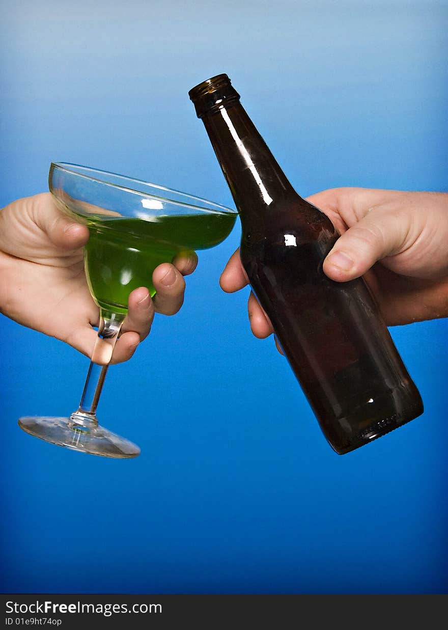 Man Toasting Beer to a Woman Toasting an Apple Martini. Man Toasting Beer to a Woman Toasting an Apple Martini