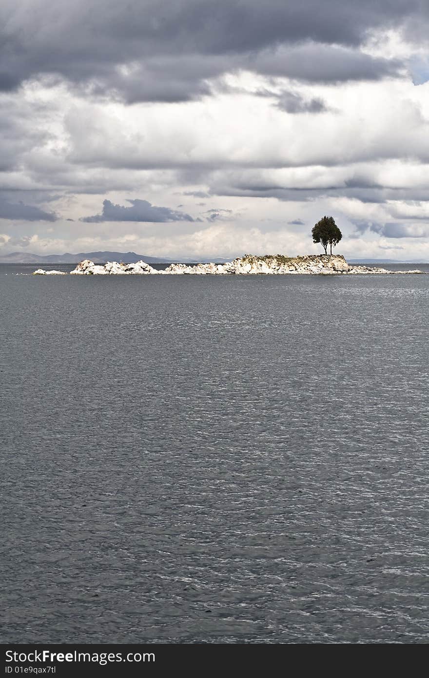 A single tree on and rocky island on Lake Titicaca. A single tree on and rocky island on Lake Titicaca.