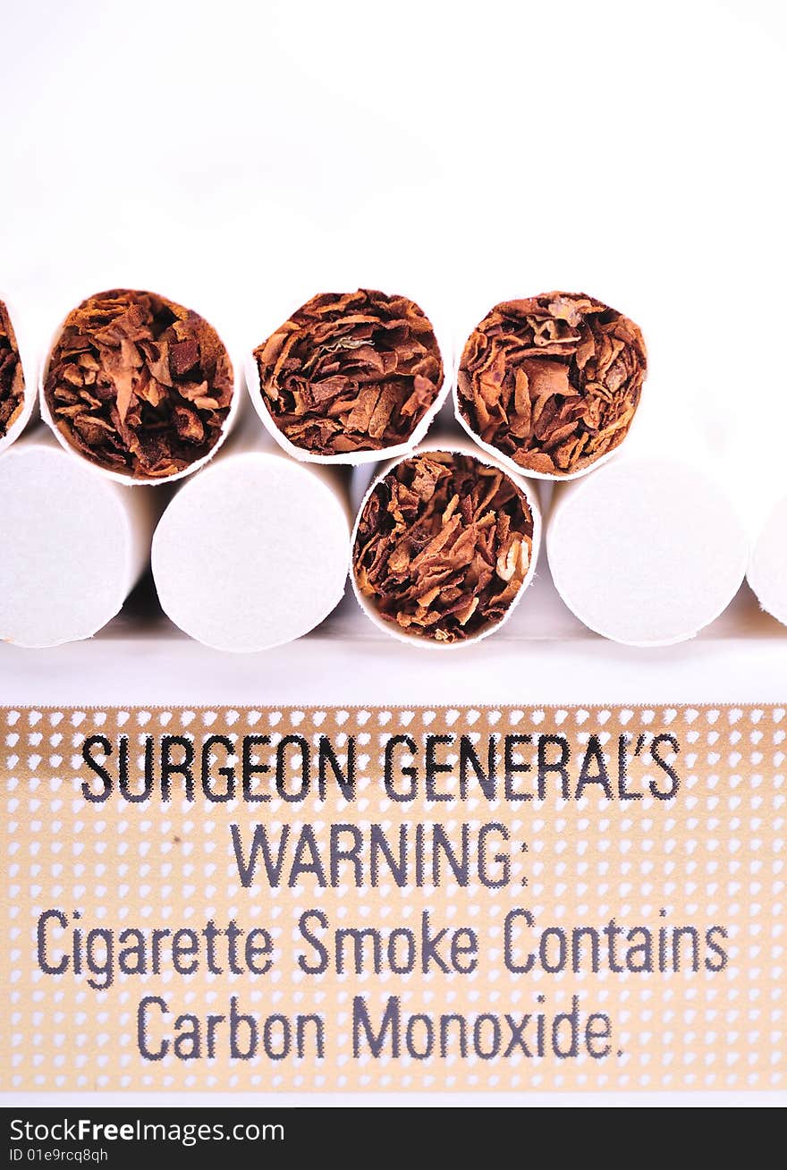 Close view of the cigarettes on the carton with warning sign isolated on white