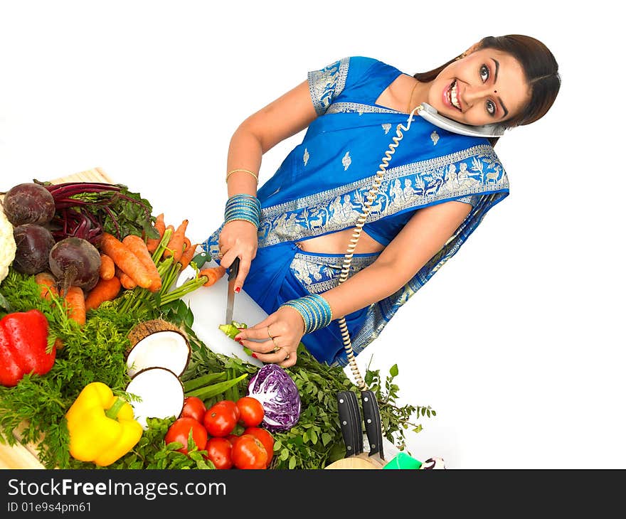 A Woman Cutting Vegetables And Talking In The Phon