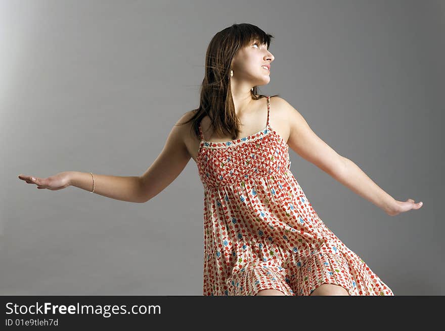 Teenager in dress on grey background. Teenager in dress on grey background