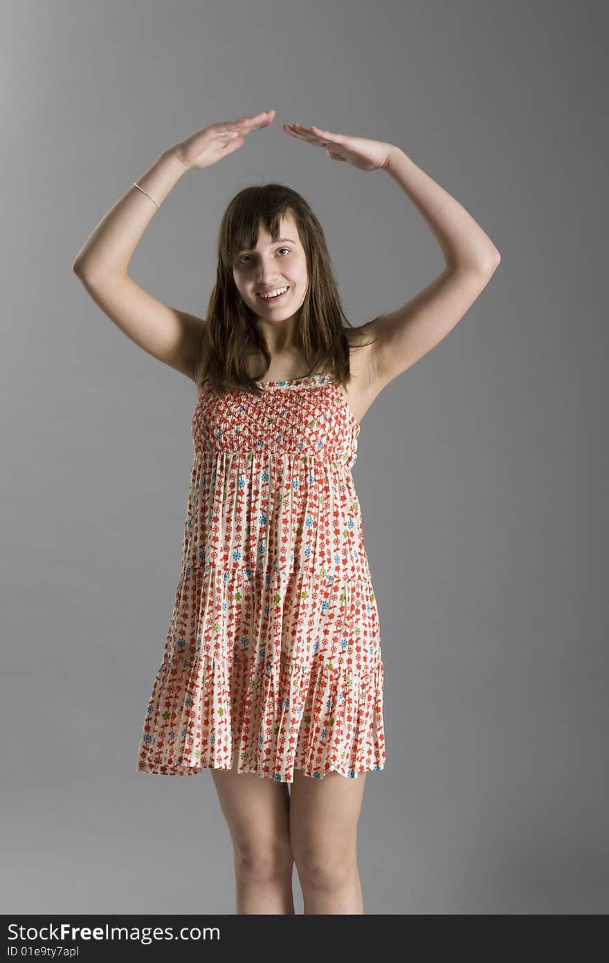 Teenager in dress on grey background. Teenager in dress on grey background