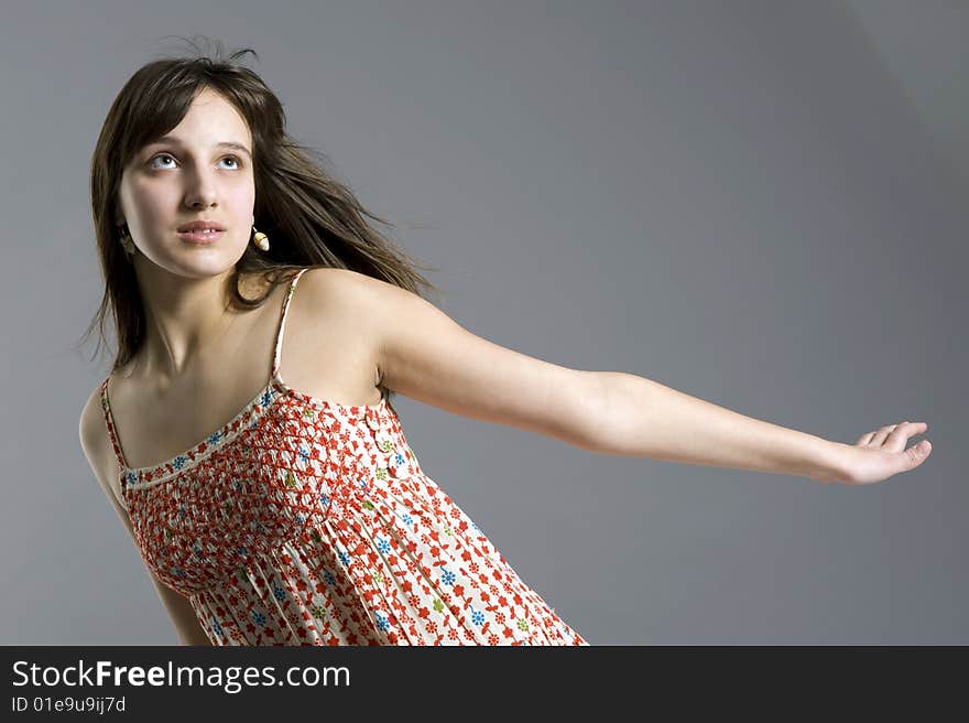 Teenager in dress on grey background. Teenager in dress on grey background