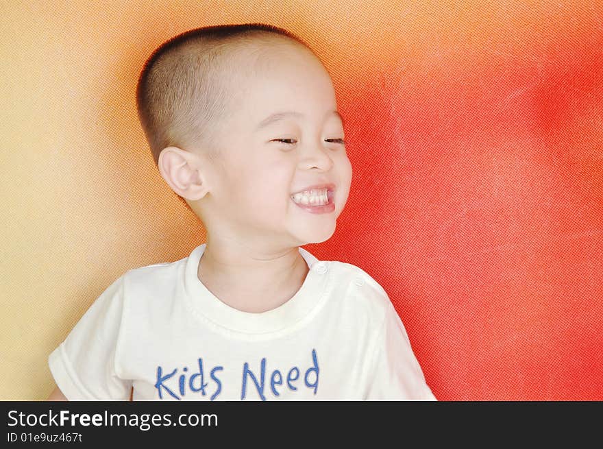 The boy the boy is laughing,his eyes like a line,white teeth exposed,he is very happy. The boy the boy is laughing,his eyes like a line,white teeth exposed,he is very happy.