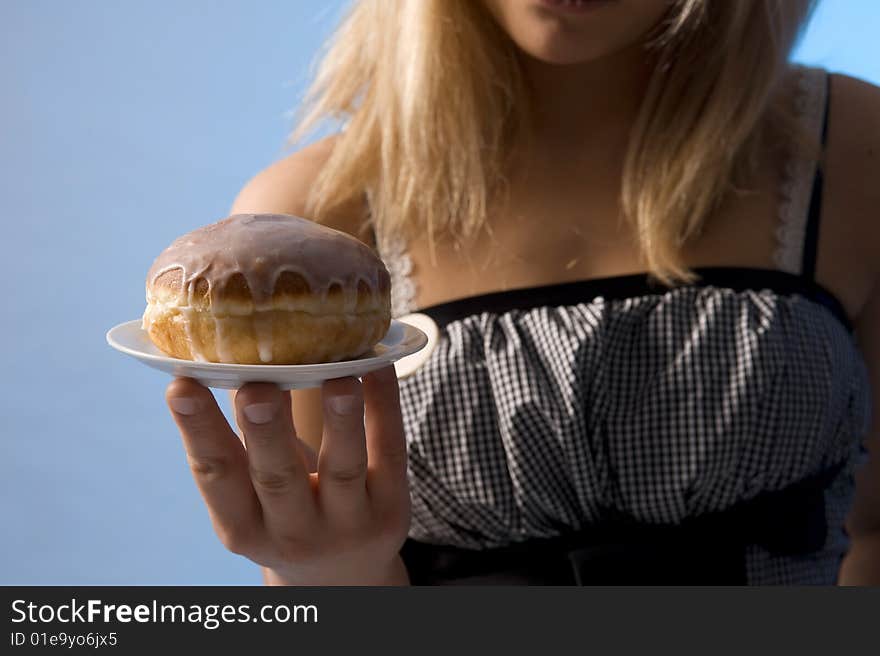 Teenager with the doughnut on the plate. Teenager with the doughnut on the plate