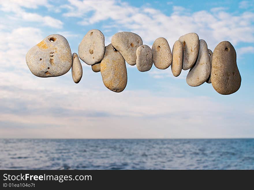 The sea pebble flies over the sea in the summer morning. The sea pebble flies over the sea in the summer morning