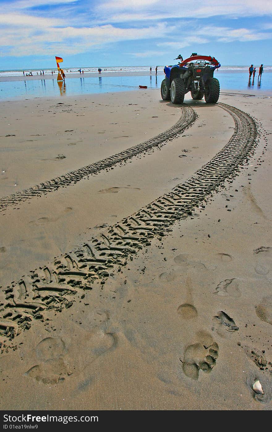 Tyre track on beach with lifeguard vehicle