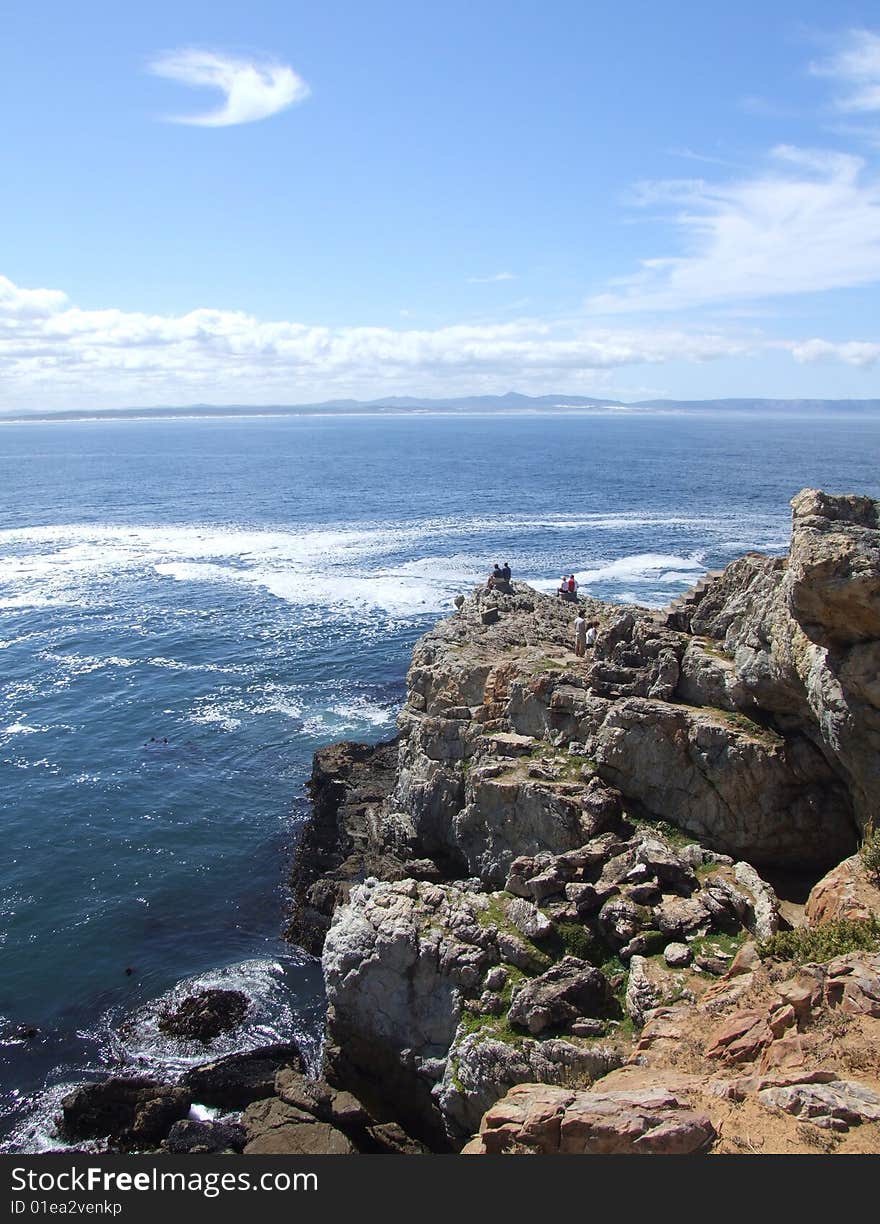 People whale watching from a rocky Outcrop in Hermannus South Africa