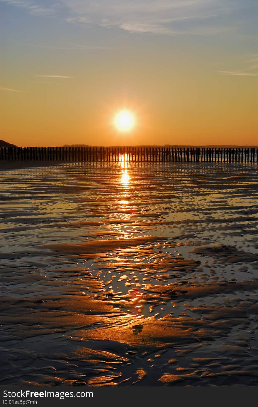 Wet empty beach with last sun over it. Wet empty beach with last sun over it