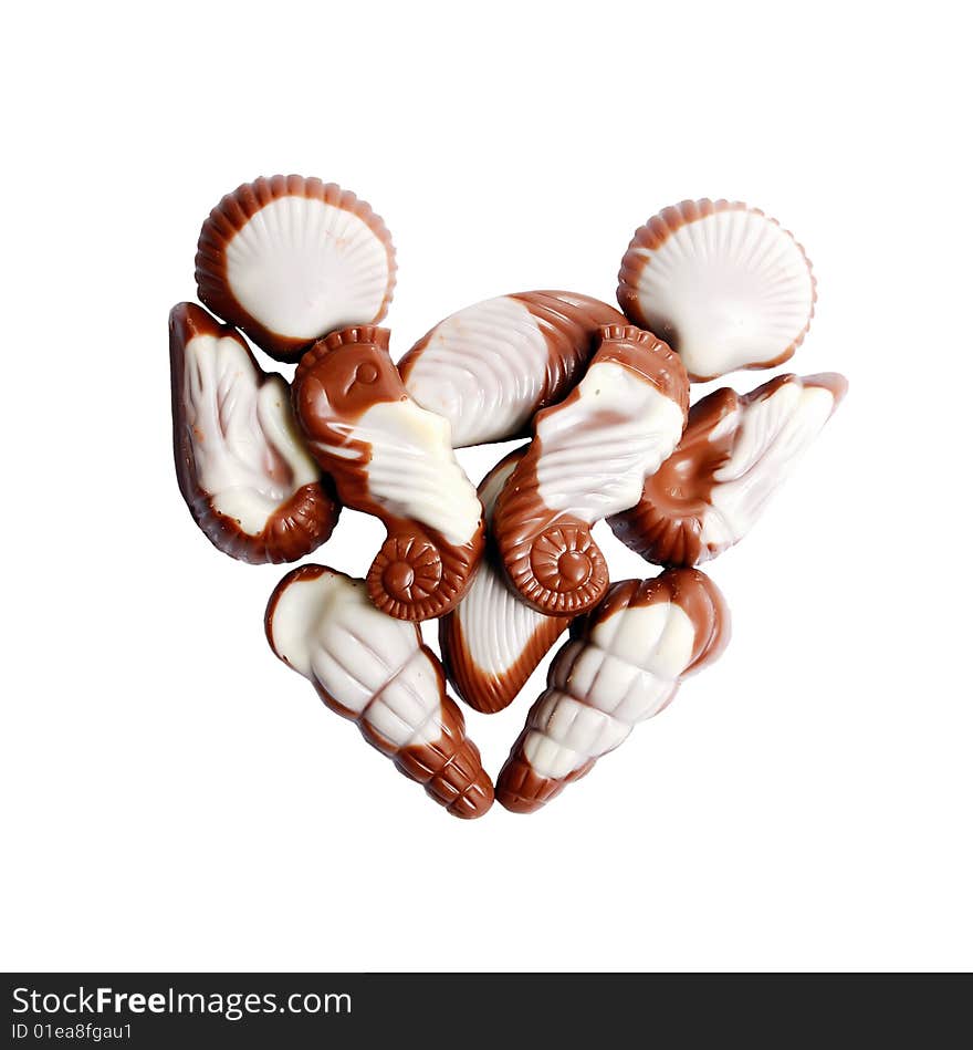 The image of sweet chocolate candies in the form of marine shellfish isolated on a white background