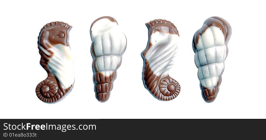 The image of sweet chocolate candies in the form of marine shellfish isolated on a white background