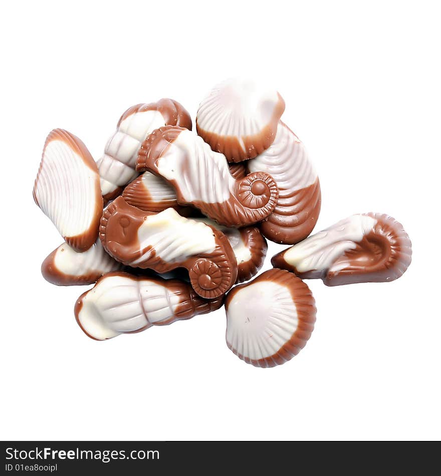 The image of sweet chocolate candies in the form of marine shellfish isolated on a white background