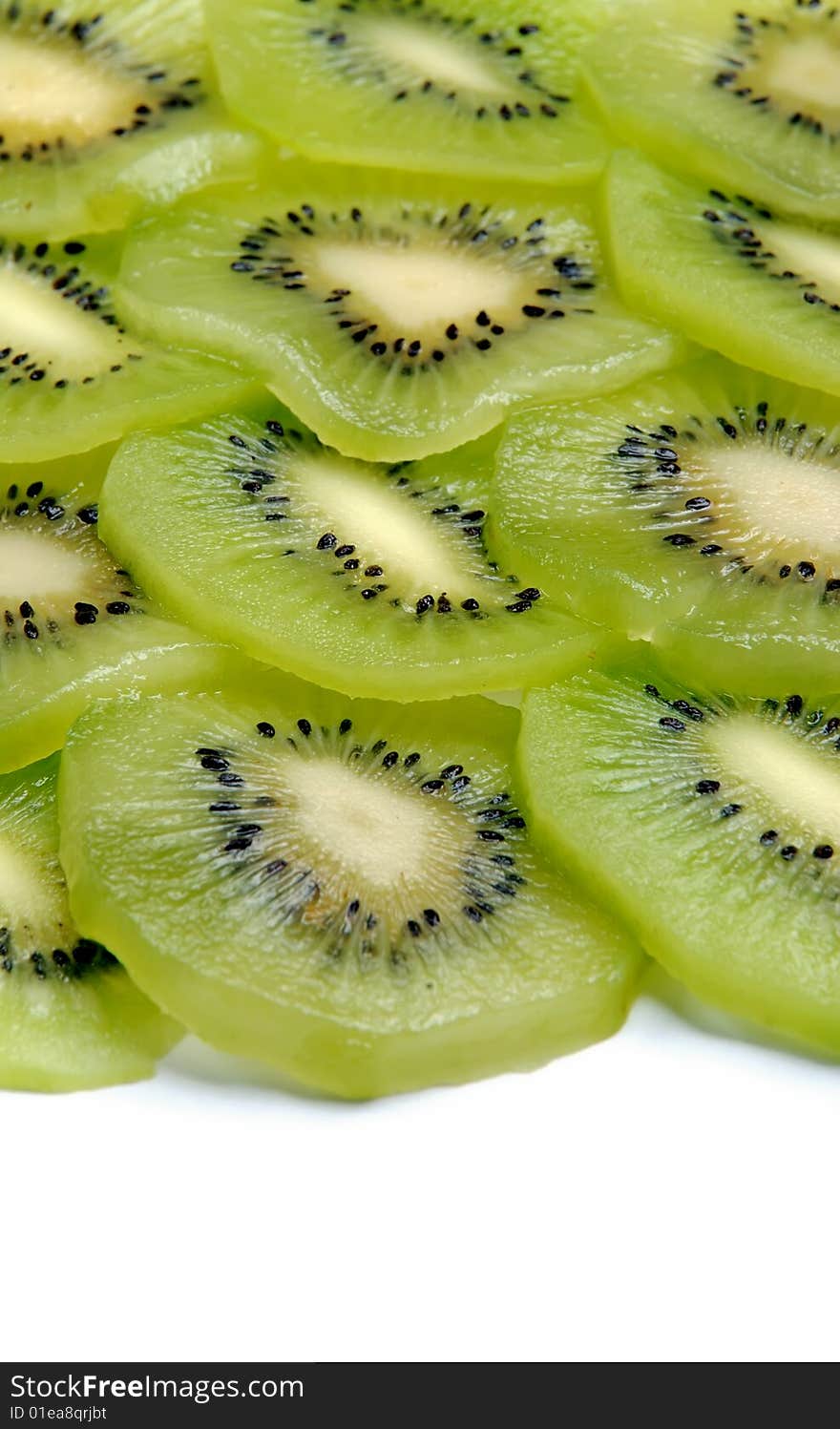 Beautiful green texture consisting of slices of kiwifruit on a white background