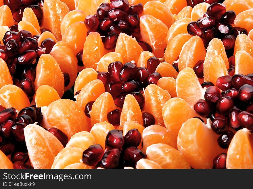 Beautiful still life of tangerine stuffed with pomegranate seeds