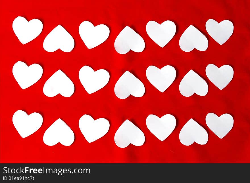 Beautiful texture of white hearts on a red background. Beautiful texture of white hearts on a red background