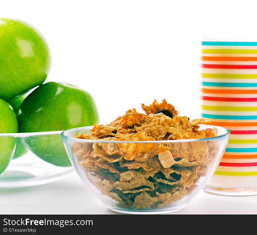 Cornflakes, glass of milk and green apples