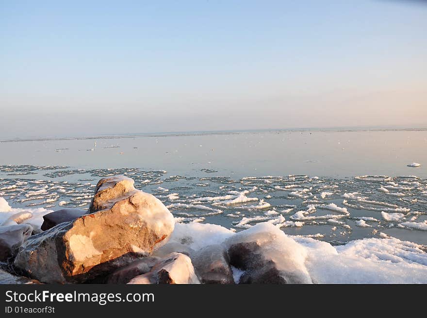 The ice of a lake is an icebound one under the blue sky in sunshine. The ice of a lake is an icebound one under the blue sky in sunshine.