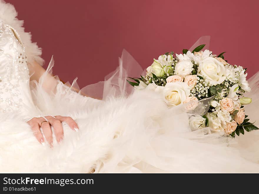 Wedding bouquet on a background of dress of the bride