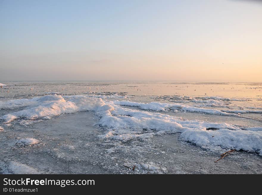 The ice of a lake is an icebound one under the blue sky in sunshine. The ice of a lake is an icebound one under the blue sky in sunshine.